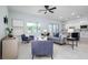 Inviting living room featuring tile floors, a ceiling fan, ample natural light, and open access to kitchen at 2354 Emerald Springs Dr, Apopka, FL 32712