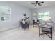Inviting living room featuring tile floors, a ceiling fan, ample natural light, and stylish furnishings at 2354 Emerald Springs Dr, Apopka, FL 32712