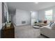 Comfortable living room featuring neutral tones, plush carpeting, and stylish furniture arrangement at 2354 Emerald Springs Dr, Apopka, FL 32712