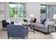 Comfortable living room with a large window showcasing the outdoor scenery, features neutral colors and stylish furniture at 2354 Emerald Springs Dr, Apopka, FL 32712