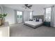 Spacious main bedroom with plush carpeting, large windows, and elegant decor at 2354 Emerald Springs Dr, Apopka, FL 32712