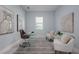 Bright home office featuring clear desk, comfortable chairs, and soft rug, creating a functional workspace at 2354 Emerald Springs Dr, Apopka, FL 32712