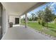 Covered patio featuring an outdoor kitchen area and a beautifully manicured lawn at 2354 Emerald Springs Dr, Apopka, FL 32712