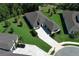 Aerial view of a stunning single-story home with a well-manicured lawn and stylish paved driveway at 25974 High Hampton Cir, Sorrento, FL 32776