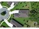 Aerial view of a home showcasing circular driveway, manicured lawn, and dark roofing at 25974 High Hampton Cir, Sorrento, FL 32776
