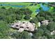 Aerial view of a luxurious residence surrounded by lush greenery, golf course, and serene lakes at 25974 High Hampton Cir, Sorrento, FL 32776