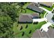 Aerial view of the home showcasing the well-maintained lawn and long driveway to the attached garage at 25974 High Hampton Cir, Sorrento, FL 32776