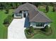 Stunning aerial view of a home with a paver driveway, manicured lawn, and elegant landscaping at 25974 High Hampton Cir, Sorrento, FL 32776