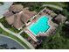 Aerial view of community pool with lounge chairs, tables, cabana and outdoor space at 25974 High Hampton Cir, Sorrento, FL 32776