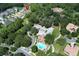 Aerial view of community featuring a pool, parking area, and mature trees surrounding the properties at 25974 High Hampton Cir, Sorrento, FL 32776