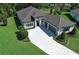 Beautiful house from above with a paver driveway, meticulous landscaping, and a gray tile roof at 25974 High Hampton Cir, Sorrento, FL 32776