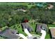 Aerial view of a home with mature landscaping near golf course featuring circular driveway and green lawn at 25974 High Hampton Cir, Sorrento, FL 32776