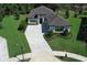 Gorgeous home from above showcasing lush greenery, professional landscaping, and a paver driveway at 25974 High Hampton Cir, Sorrento, FL 32776