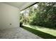 Paver patio with a view of the green lawn and surrounding trees at 25974 High Hampton Cir, Sorrento, FL 32776