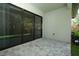 Paver patio with large sliding glass doors leading inside, with a Ring security system sign at 25974 High Hampton Cir, Sorrento, FL 32776