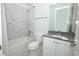 Bathroom featuring marble tile, granite counters, a shower/tub combination, and white cabinets at 25974 High Hampton Cir, Sorrento, FL 32776