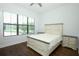 Bedroom showcasing a large window, neutral furniture, and hardwood floors at 25974 High Hampton Cir, Sorrento, FL 32776