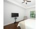 Bright bedroom with a ceiling fan, hardwood floors, and a sleek TV on a stand at 25974 High Hampton Cir, Sorrento, FL 32776