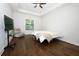 Bright bedroom features hardwood floors, a tray ceiling, and natural light at 25974 High Hampton Cir, Sorrento, FL 32776