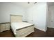 Charming bedroom with a distressed wood bed frame and matching nightstands on dark wood floors at 25974 High Hampton Cir, Sorrento, FL 32776