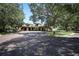Beautiful clubhouse entrance with covered entryway and lush landscaping at 25974 High Hampton Cir, Sorrento, FL 32776