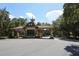 Elegant community gate entrance with stone accents and covered entry for security and style at 25974 High Hampton Cir, Sorrento, FL 32776