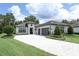 Beautiful home featuring a three-car garage, well-maintained landscaping, and a stylish gray and white color scheme at 25974 High Hampton Cir, Sorrento, FL 32776