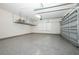 Spacious two car garage featuring epoxy flooring and overhead storage racks for organization at 25974 High Hampton Cir, Sorrento, FL 32776