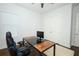 Home office featuring a black desk, ergonomic chair, and double doors at 25974 High Hampton Cir, Sorrento, FL 32776