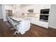 Modern kitchen features granite countertops, stainless steel appliances, and a breakfast bar with seating at 25974 High Hampton Cir, Sorrento, FL 32776