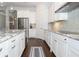 Modern kitchen features stainless steel appliances, granite counters and white cabinets at 25974 High Hampton Cir, Sorrento, FL 32776