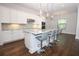 Bright kitchen boasts granite countertops, a center island with seating, and herringbone backsplash at 25974 High Hampton Cir, Sorrento, FL 32776
