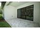 Covered patio featuring stone pavers and sliding glass doors offering seamless indoor-outdoor living at 25974 High Hampton Cir, Sorrento, FL 32776