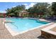 Community pool with lounge chairs, tables, and a cabana providing a relaxing outdoor space at 25974 High Hampton Cir, Sorrento, FL 32776