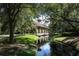 Picturesque water feature with covered walkway, landscaping, and a serene ambiance at 25974 High Hampton Cir, Sorrento, FL 32776