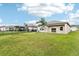 A spacious backyard with lush green grass, complemented by a well-maintained exterior at 3093 Neverland Dr, New Smyrna Beach, FL 32168