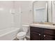 Bathroom featuring white tile in shower, vanity and wood floor at 3093 Neverland Dr, New Smyrna Beach, FL 32168