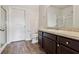 Well-lit bathroom featuring dark wood cabinets, and a glass-enclosed shower at 3093 Neverland Dr, New Smyrna Beach, FL 32168