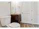 Bathroom featuring a toilet, vanity with granite countertop and wood flooring at 3093 Neverland Dr, New Smyrna Beach, FL 32168