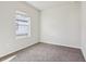 A bedroom with neutral carpet and a bright window offers a calm and inviting space at 3093 Neverland Dr, New Smyrna Beach, FL 32168
