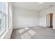 Large sunny bedroom with neutral walls, carpet and a view of the bathroom at 3093 Neverland Dr, New Smyrna Beach, FL 32168