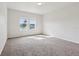 Spacious bedroom featuring two large windows overlooking a serene lake view and filled with natural light at 3093 Neverland Dr, New Smyrna Beach, FL 32168