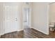 Entryway with wood flooring and a view of a bathroom with a toilet and sink at 3093 Neverland Dr, New Smyrna Beach, FL 32168