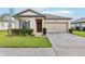 Charming single-story home featuring a well-manicured lawn and attached two-car garage at 3093 Neverland Dr, New Smyrna Beach, FL 32168