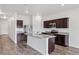 Kitchen featuring stainless steel appliances, granite countertops, dark wood cabinets and a large island at 3093 Neverland Dr, New Smyrna Beach, FL 32168