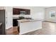Kitchen with stainless steel appliances, dark cabinetry, island and granite countertops at 3093 Neverland Dr, New Smyrna Beach, FL 32168