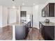 Open kitchen with stainless steel appliances, dark cabinetry and a spacious granite island at 3093 Neverland Dr, New Smyrna Beach, FL 32168