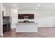 Kitchen featuring stainless steel appliances, granite countertops, dark wood cabinets and open concept to living area at 3093 Neverland Dr, New Smyrna Beach, FL 32168