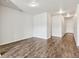 A bright open-plan living room with wood-look flooring and a white door at 3093 Neverland Dr, New Smyrna Beach, FL 32168