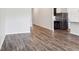 A bright open-plan living room with wood-look flooring and a white wall at 3093 Neverland Dr, New Smyrna Beach, FL 32168